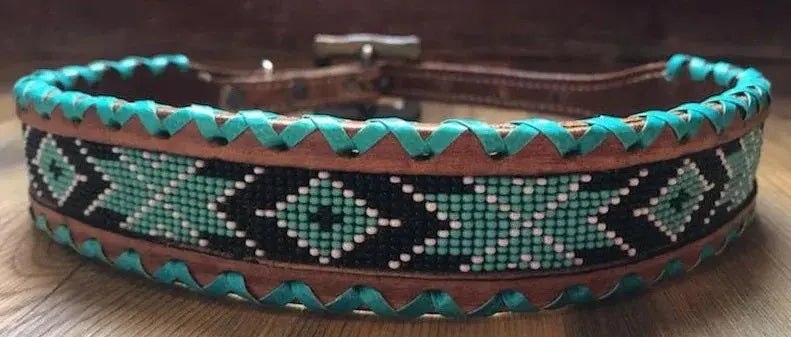 Genuine leather dog collar with teal, white, and black southwest beaded inlay design, a rawhide wrapped edge