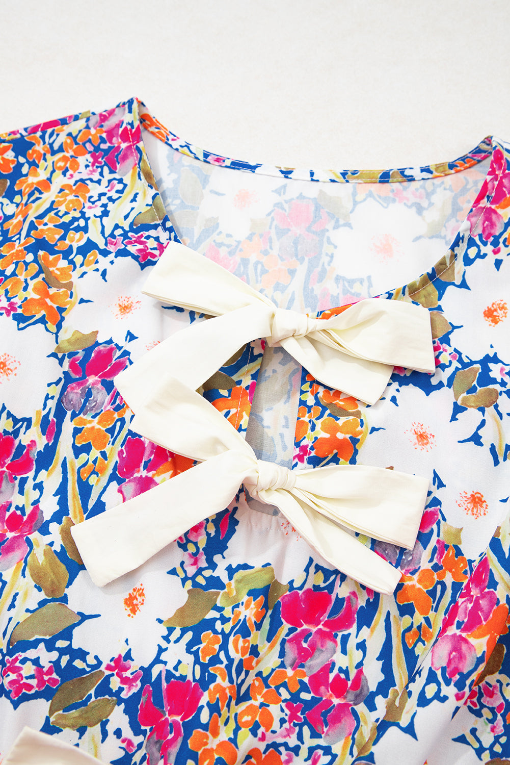 Floral Bow Sleeveless Slit Peplum Blouse