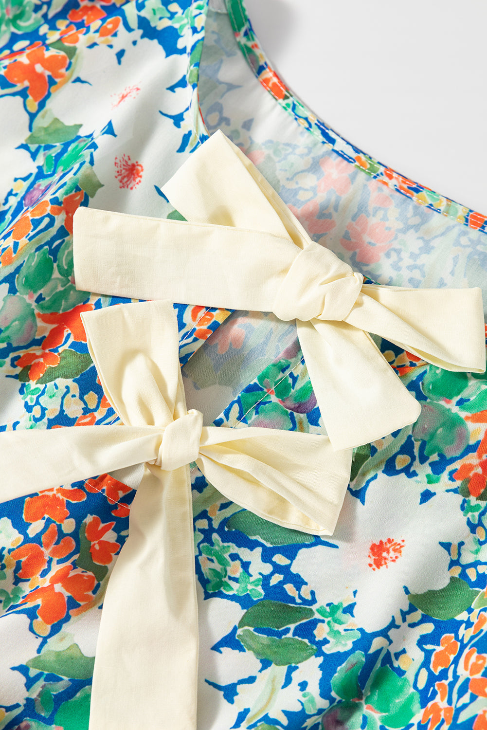 Floral Bow Sleeveless Slit Peplum Blouse